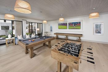 Game room with pool table, shuffleboard and wet bar